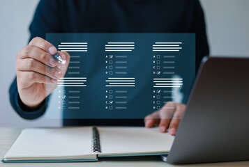 assessment survey online. Businessman with evaluating questionnaire on online laptop computer....