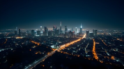 Fototapeta premium Vibrant Cityscape at Night: An aerial view showcases the illuminated skyline of a modern urban metropolis