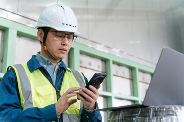 asian engineer working with laptop in factory