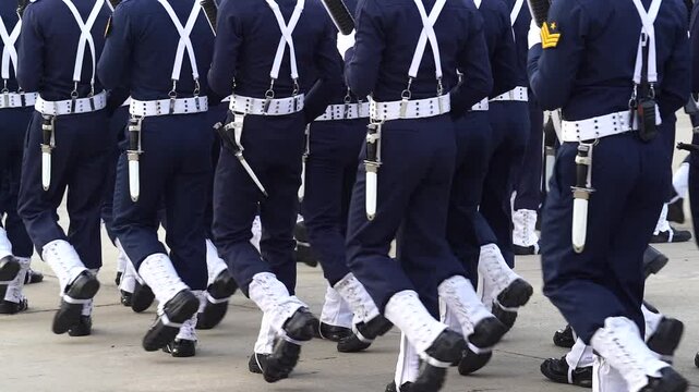 A line of soldiers is marching in a parade. platoon military army marche street slowmotion