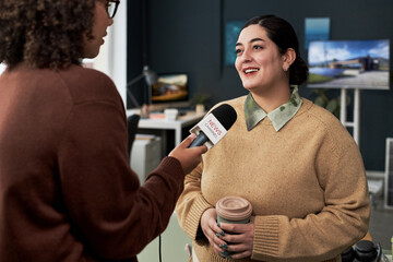 Businesswoman talking to journalist during interview in office