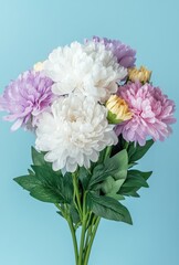 Beautiful Arrangement of Colorful Artificial Flowers on a Soft Blue Background for Home Decoration and Creative Projects