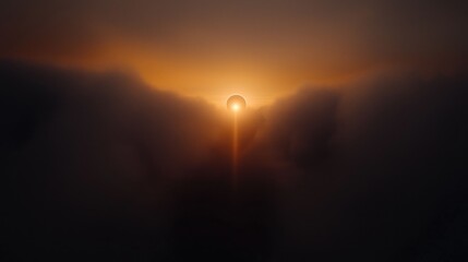 Sunrise through misty mountain peaks