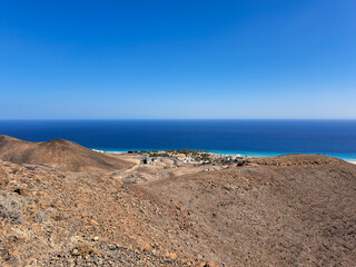 green coast and rocky hills on Fuerteventura, desert roads