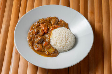 Japanese curry rice with beef Asian cooking recipe served on a bamboo background 