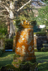 
Old gravestone in the morning sun with colorful moss in a cemetery in Luss, Loch Lomond, Scotland