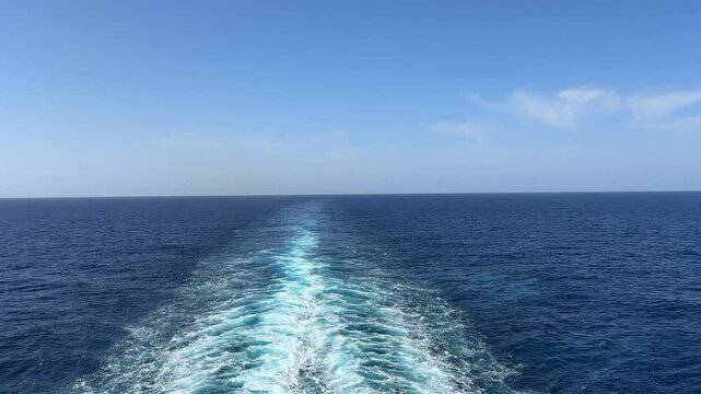 Wake from a cruise ship in the Atlantic ocean with blue sea and sky