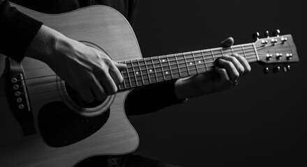 Fototapeta premium Man playing acoustic guitar music instrument in dark style, concept for hobby, music performance event and practicing guitar skills at home, for musical blog