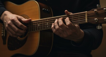 Man plays acoustic guitar in darkness to creates emotional connection, strumming chords on fretboard for musician practice, guitar lessons, or live musical performance