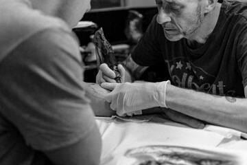 Tattooing an angel on the arm