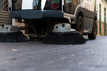 street cleaning machine passing through pedestrian street