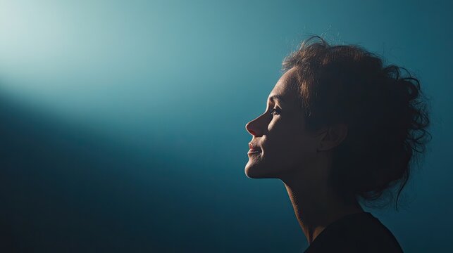 close-up shot of thoughtful individual silhouetted against softly illuminated background symbolizing introspection