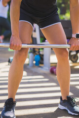 woman lifting weight bar