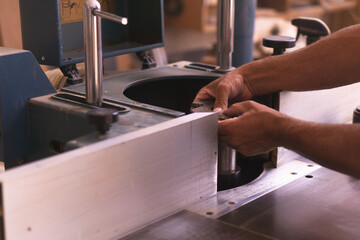 carpenter changing cutter disc of his industrial machine