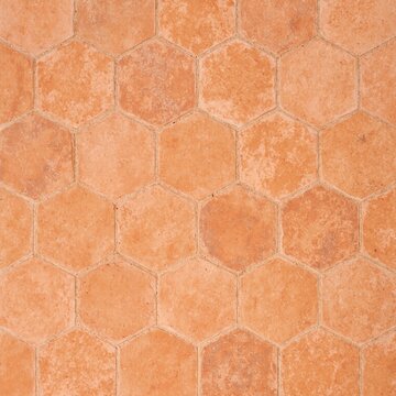 Hexagonal terracotta tile floor in warm earthy tones