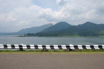 Black and white Steel Safety Road Barrier on reservoir road. For graphic design, 3D rendering or banner background