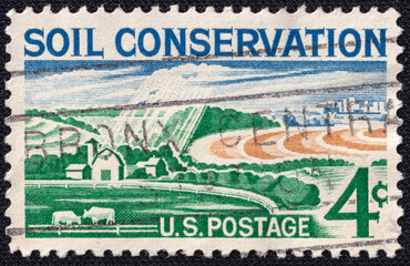 U.S. postage stamp issued in 1959 promoting soil conservation. Features a rural landscape with farmland, trees, and contour plowing, symbolizing sustainable agriculture.