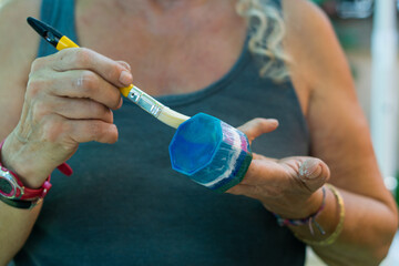 close up of hand holding a hammer