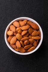 Roasted or raw peeled almonds in bowl