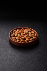 Roasted or raw almond nuts in shell in bowl