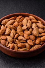 Roasted or raw almond nuts in shell in bowl
