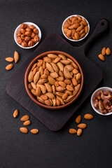 Roasted or raw almond nuts in shell in bowl