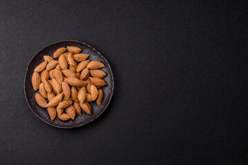 Roasted or raw almond nuts in shell in bowl