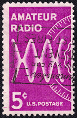 U.S. postage stamp issued in 1964 honoring amateur radio operators. Features a stylized radio wave and frequency dial in a magenta color scheme.
