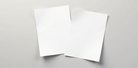 Two sheets of white paper, slightly overlapping, on a neutral background , sheets, close-up