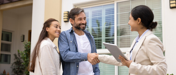 Happy family couple and real estate agent woman shaking hands, finding accommodations for rent,...