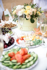 table filled with food with a bouquet of flowers