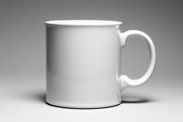 Fototapeta premium A plain white ceramic mug with a C-shaped handle, perfect for hot beverages.