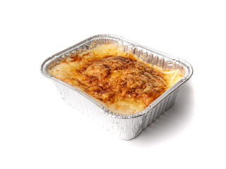 Lasagna portion in aluminium foil tray isolated. Oven baked lasagne for heating, container, airplane food