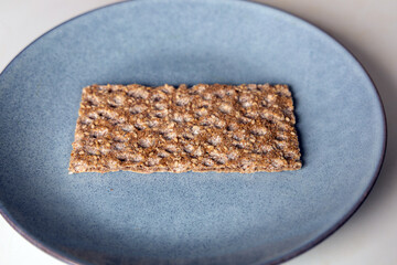 One piece of crunchy crispbread on a plate. High quality photo