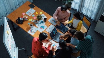 Top down view of business team putting hand together while discussing about Ux Ui design for mobile...