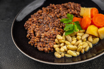 Lentils and vegetables vegetarian main course, bean, potatoe, carrot tasty fresh gourmet food background on the table rustic food top view copy space keto and paleo diet vegetarian and vegan food