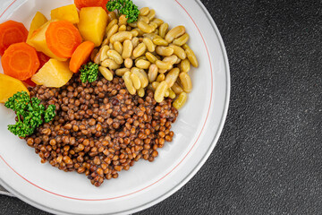 Lentils and vegetables vegetarian main course, bean, potatoe, carrot tasty fresh gourmet food background on the table rustic food top view copy space keto and paleo diet vegetarian and vegan food