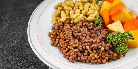 Lentils and vegetables vegetarian main course, bean, potatoe, carrot tasty fresh gourmet food background on the table rustic food top view copy space keto and paleo diet vegetarian and vegan food