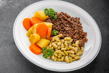 Lentils and vegetables vegetarian main course, bean, potatoe, carrot tasty fresh gourmet food background on the table rustic food top view copy space keto and paleo diet vegetarian and vegan food