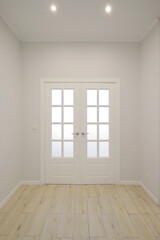 Hallway with white interior door with windows
