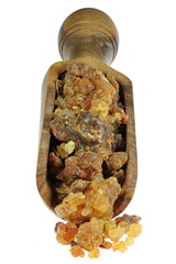 myrrh resin from Oman in an olive wood scoop isolated on white background