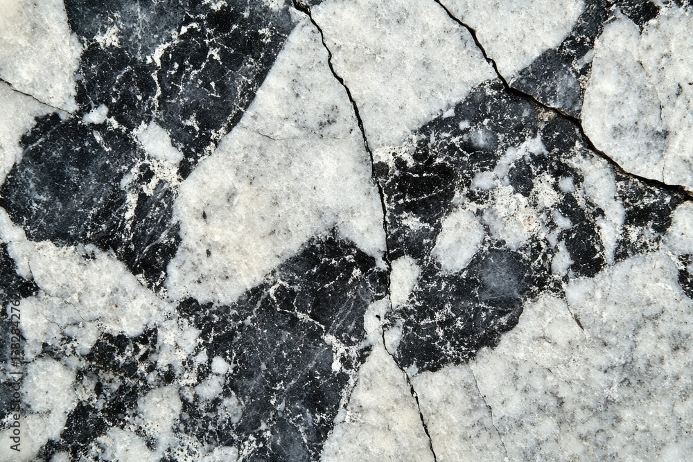 Poster black and white marble stone with cracks, showing intricate patterns and textures.