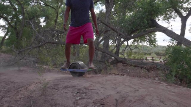Man Riding a OneWheel+ on Dirt in Slow Motion and wrecks