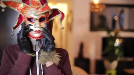 Spooky alien with big eyes disguised with a carnival mask 