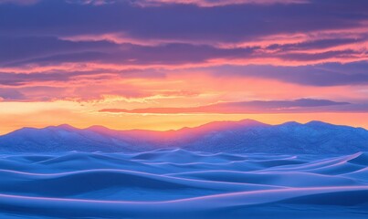 Fototapeta premium Colorful sunset above ocean waves with distant mountains and clouds.