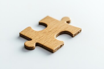Fototapeta premium A single wooden puzzle piece placed on a white surface