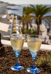 Celebration, birthday party, drinking of cava or champagne sparkling wine in vacation resort Costa Adeje, Tenerife, Canary islands winter sun vacation, Spain