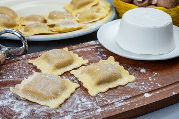 Italian food, fresh home made stuffed pasta ravioli dumplings with ricotta soft cheese and champignons porcini mushrooms, Parma, Emilia Romagna, Italy