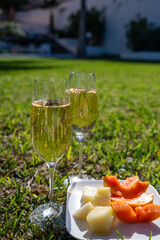 Celebration, birthday party, drinking of cava or champagne sparkling wine with tropical fruits in vacation resort Costa Adeje, Tenerife, Canary islands winter sun vacation, Spain