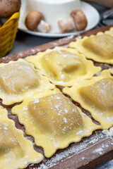 Italian food, fresh home made stuffed pasta ravioli dumplings with ricotta soft cheese and champignons porcini mushrooms, Parma, Emilia Romagna, Italy